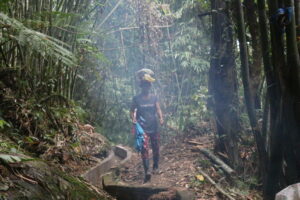 A woman beneficiary takes part in hauling sand for the repair of their irrigation system.