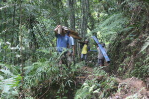 Community members work hand in hand to haul materials for their communal irrigation system