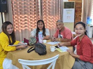 BLGU representatives from Laya West, community volunteers, and MindWell staff gather together during the activity.