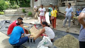 CorDisRDS staff demonstrate the proper feed processing procedure using locally available ingredients