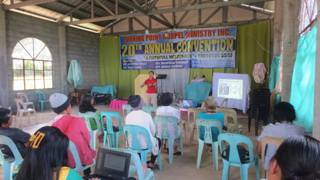 A CorDisRDS staff member explains key concepts while participants listen attentively during the community-based disaster risk management training.